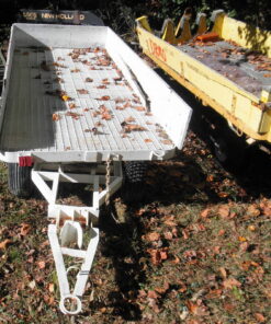 3920-00-165-4135 30431 MIL-T-46705 Trailer, Platform, Warehouse. Trailer deck measures approximately 9' long x 4' wide. Stake sides show damage. Two available; varying condition. Conex Area